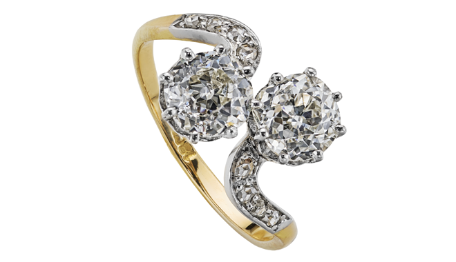 Early C20th.<br>18ct Gold & Platinum.<br>An Antique Cut Diamond set 'Toi et Moi' Ring<br>with Diamond inlaid Shoulders<br>(Main Stones: 1.19cts & 1.10cts = 2.29cts) 